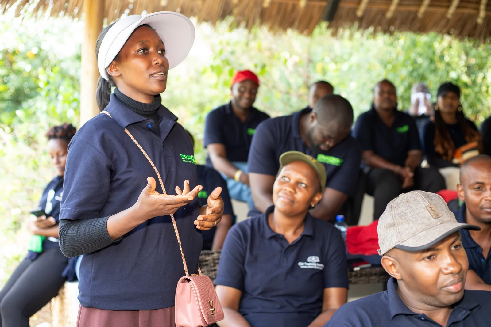 A woman contributing to a group discussion while others listen