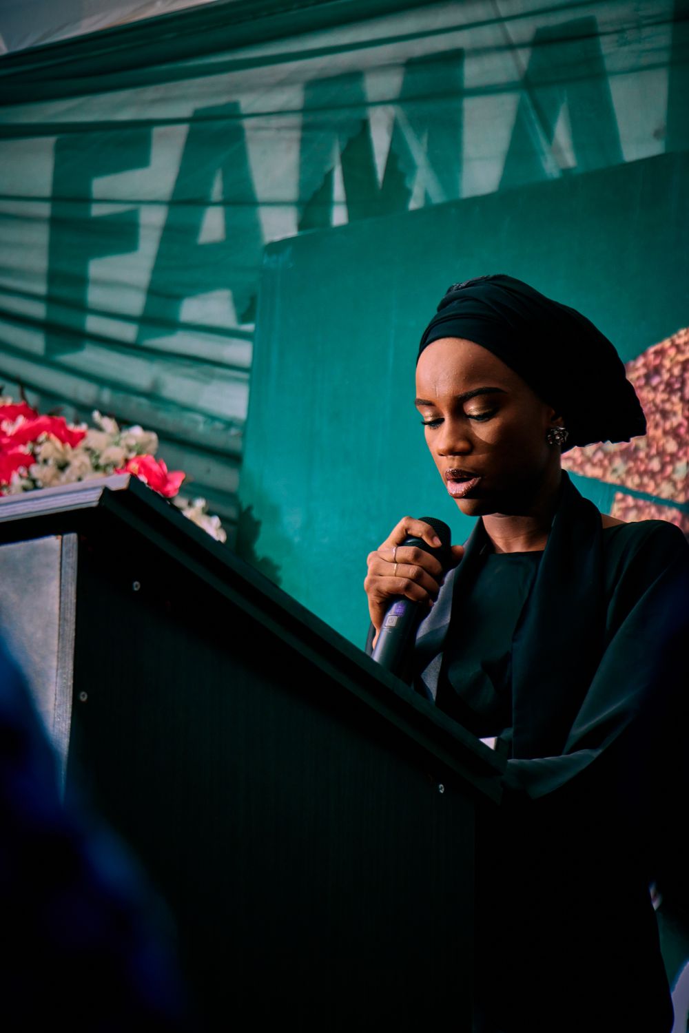 A woman presenting at a podium in Kaduna, Nigeria